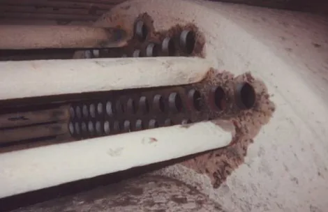 Inside a steam boiler after tube removal, showing scale on the water side