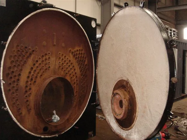 Steam boiler in the P.J. Guerin workshop with front tubeplate exposed and the insulated front door swung open